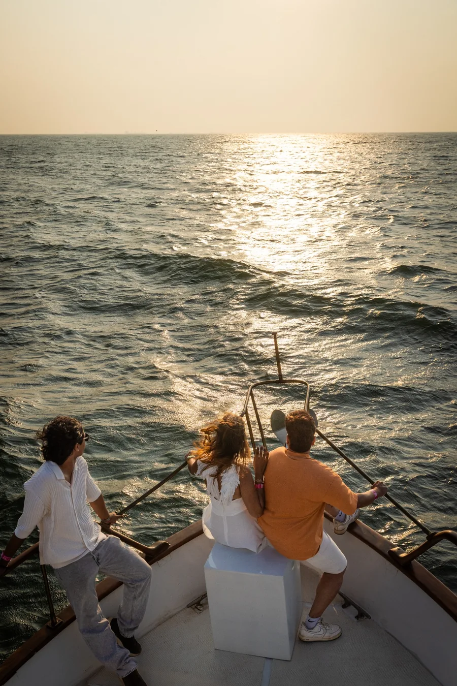 Guests watching the sunset from the bow of Solita